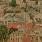 a view of a city from the top of a hill