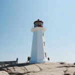 white and black lighthouse under blue sky